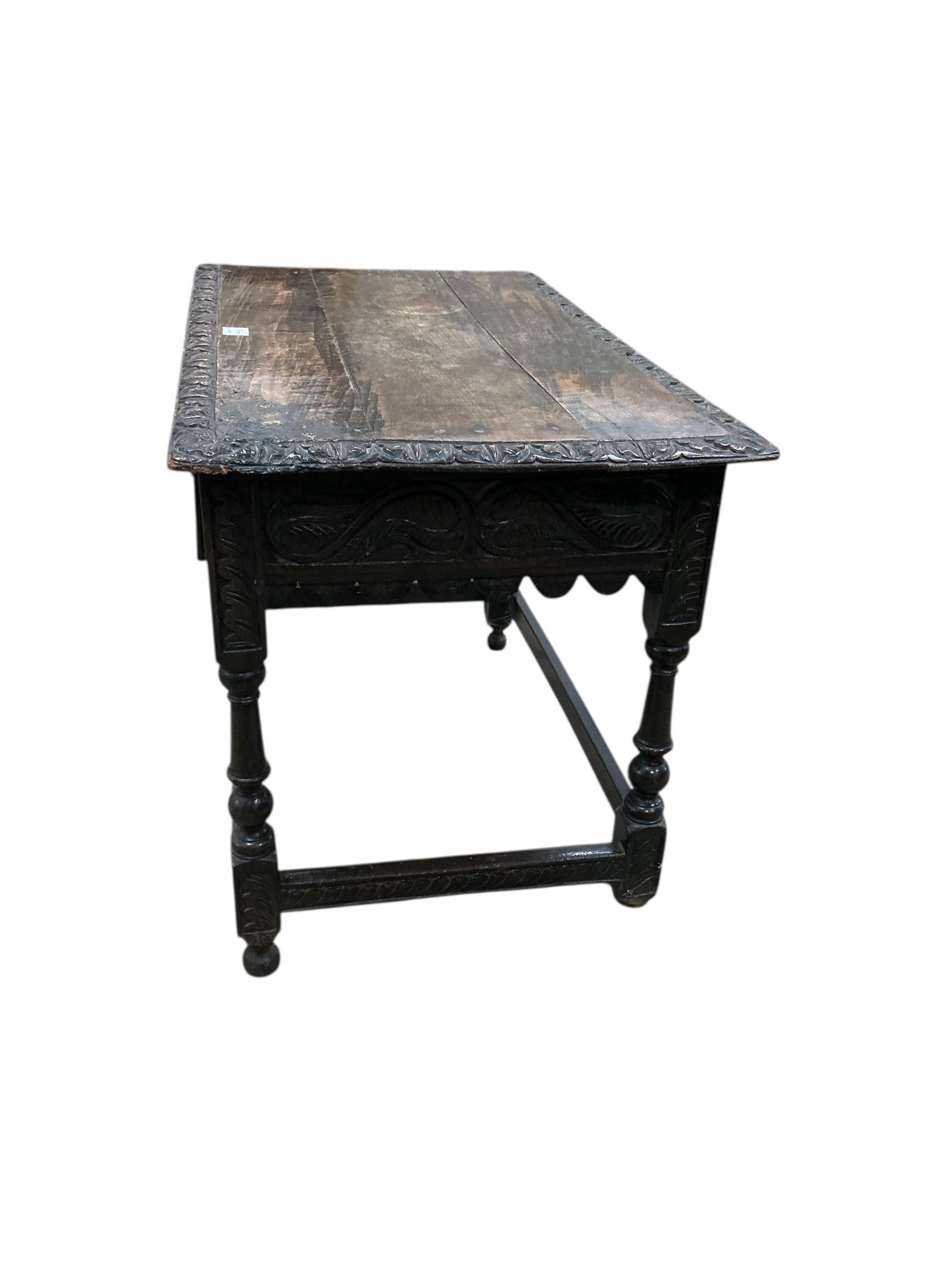 An early 18th century oak side table, later carved, width 99cm, depth 60cm, height 74cm